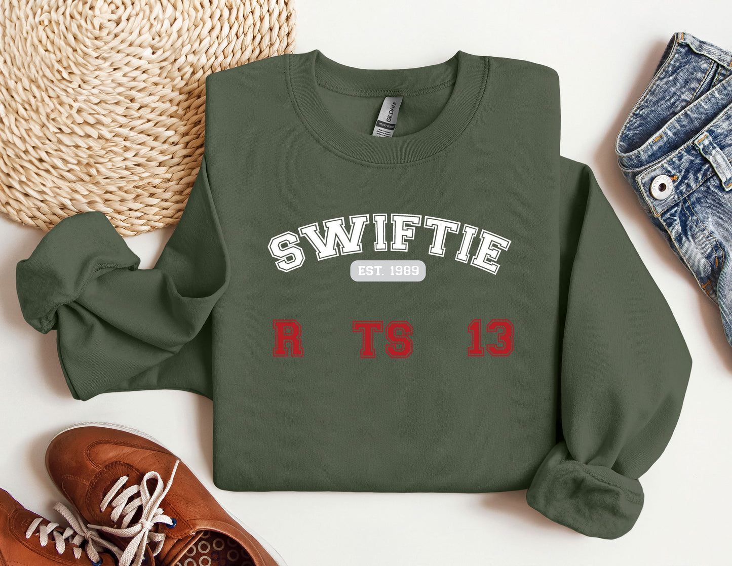 a sweater with the words swiffie on it next to a pair of shoes