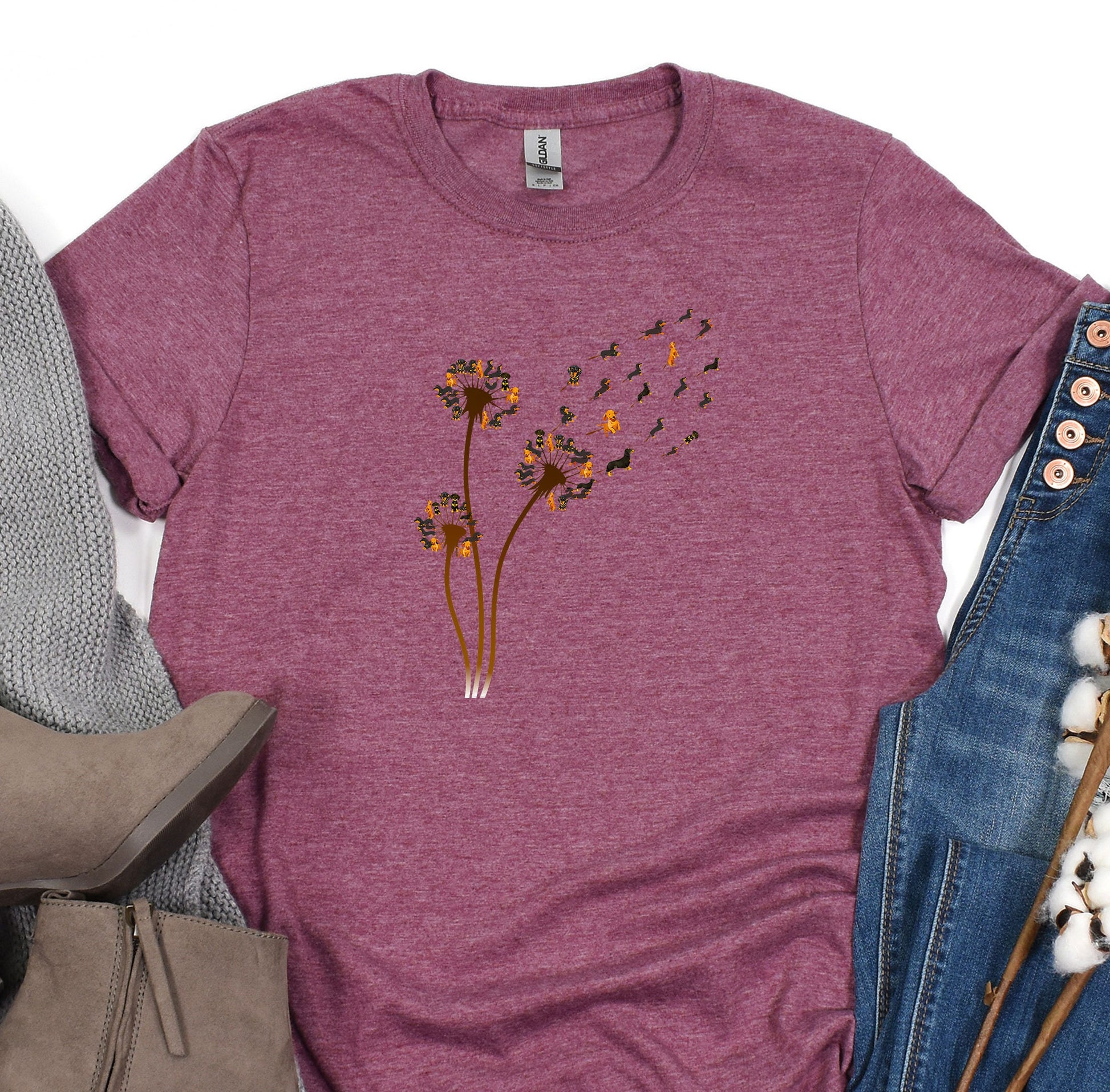 a women&#39;s t - shirt with a dandelion design on it