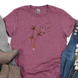 a women's t - shirt with a dandelion design on it