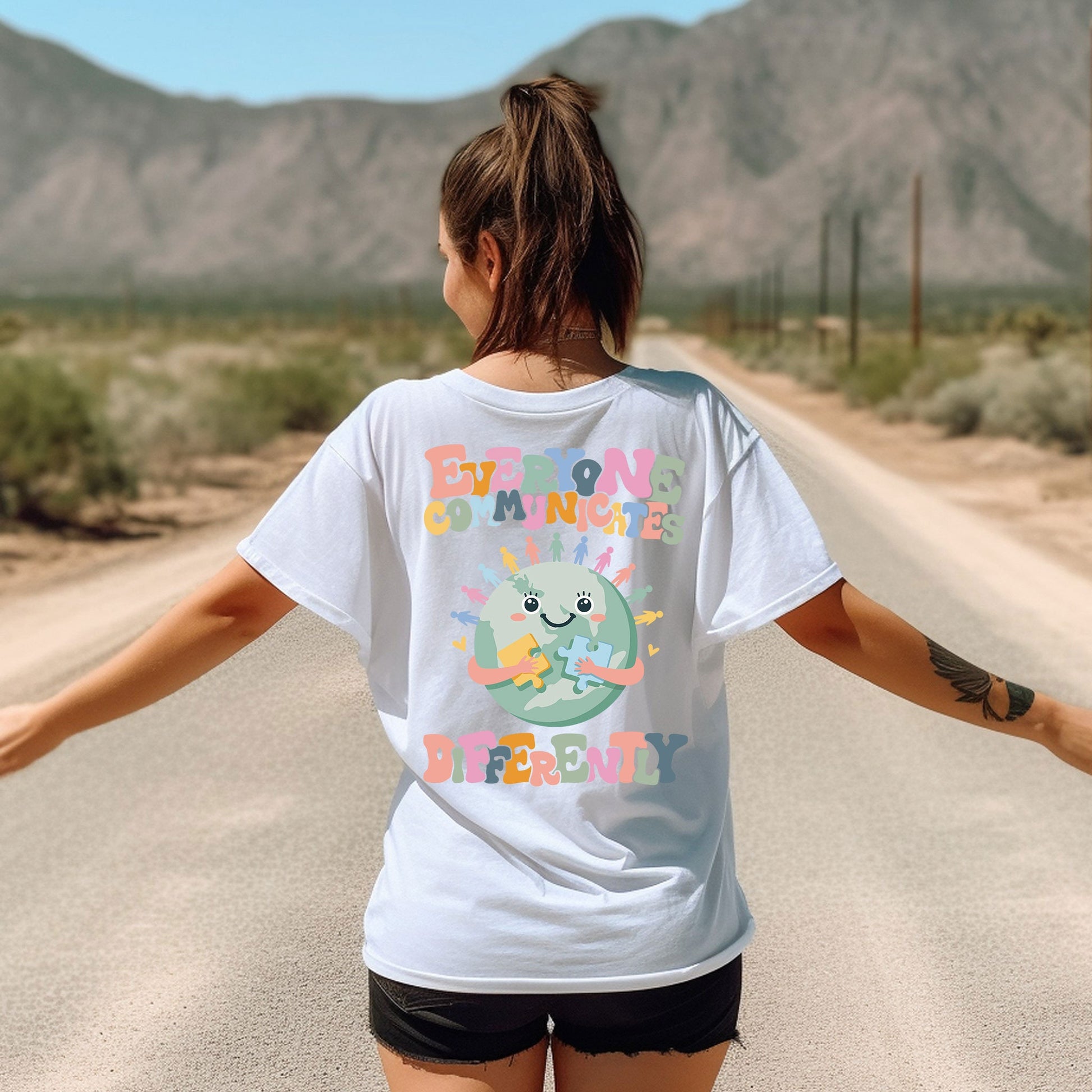 a woman walking down a road with her arms outstretched