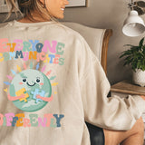 a woman sitting in a chair wearing a sweatshirt