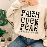 a woman wearing a sweatshirt that says faith over fear