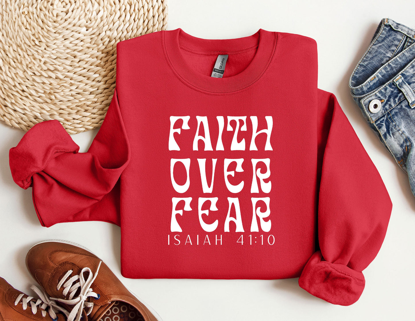 a red sweatshirt with the words faith over fear printed on it