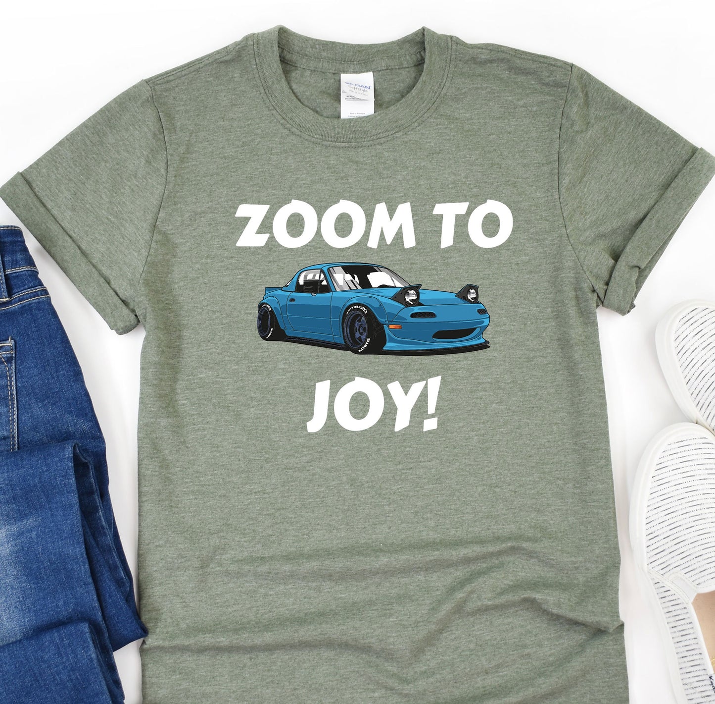 a t - shirt that says zoom to joy next to a pair of jeans