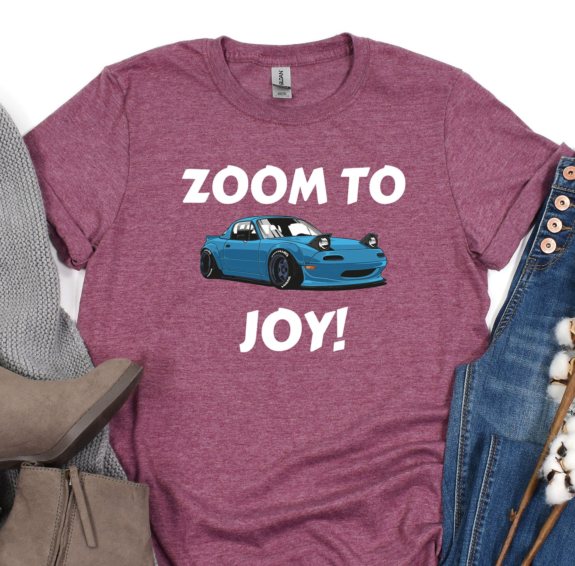 a t - shirt that says zoom to joy next to a pair of jeans