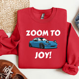 a red shirt with a blue car on it that says zoom to joy