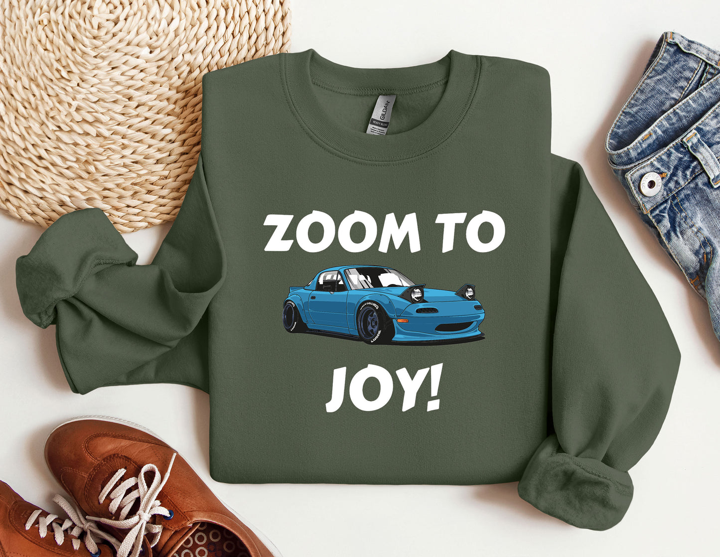 a green sweatshirt with a blue car on it