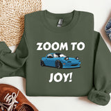 a green sweatshirt with a blue car on it