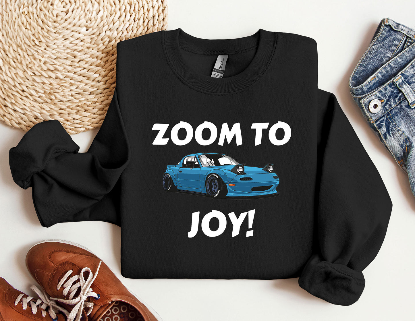 a black shirt with a blue car and the words zoom to joy on it