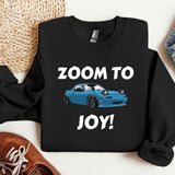 a black shirt with a blue car and the words zoom to joy on it