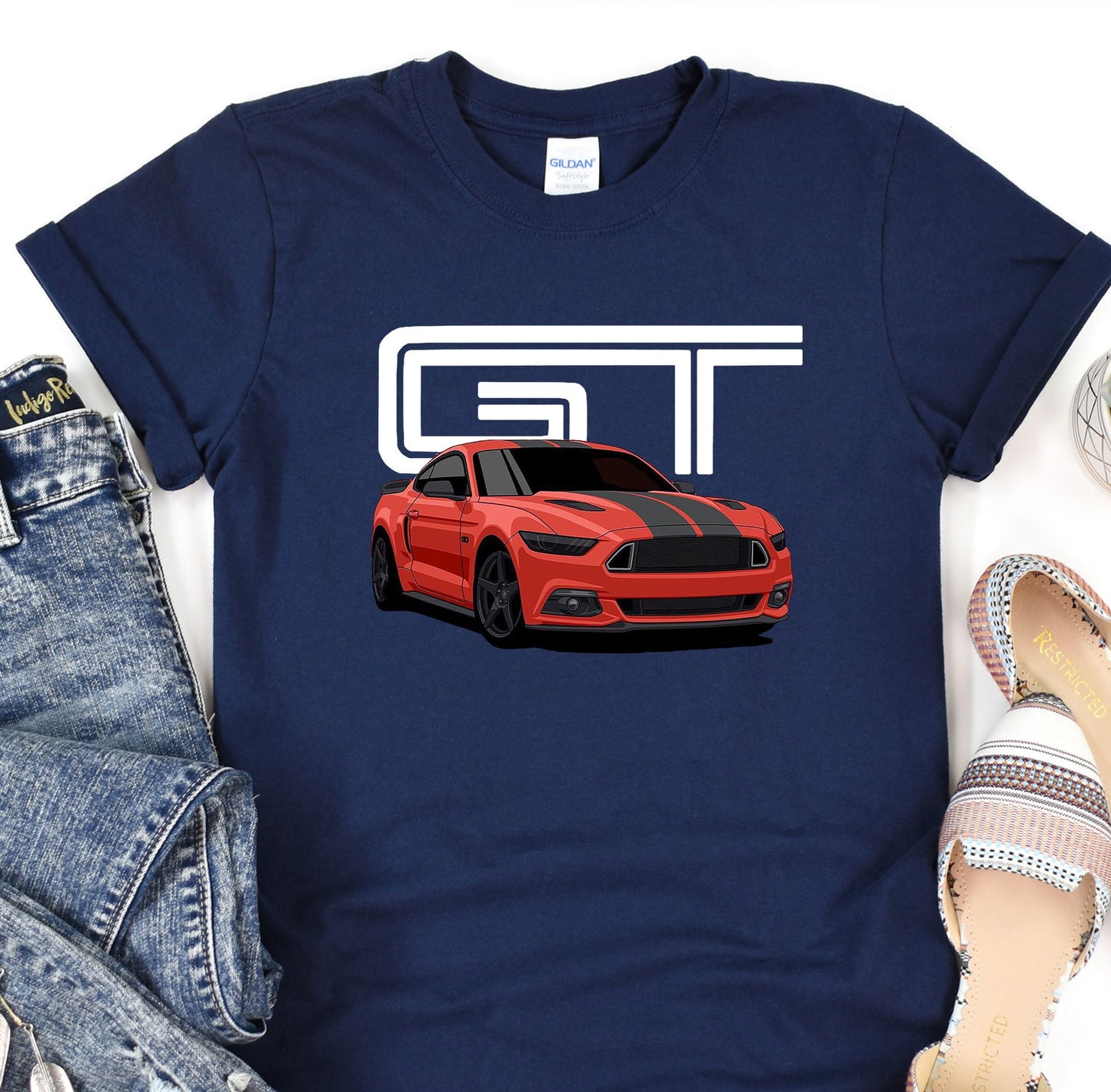 a t - shirt with a picture of a red mustang on it