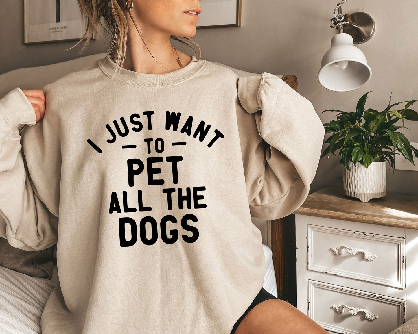 a woman wearing a sweatshirt that says i just want to pet all the dogs