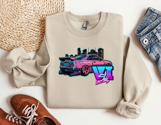 a sweater with a car on it next to a pair of shoes