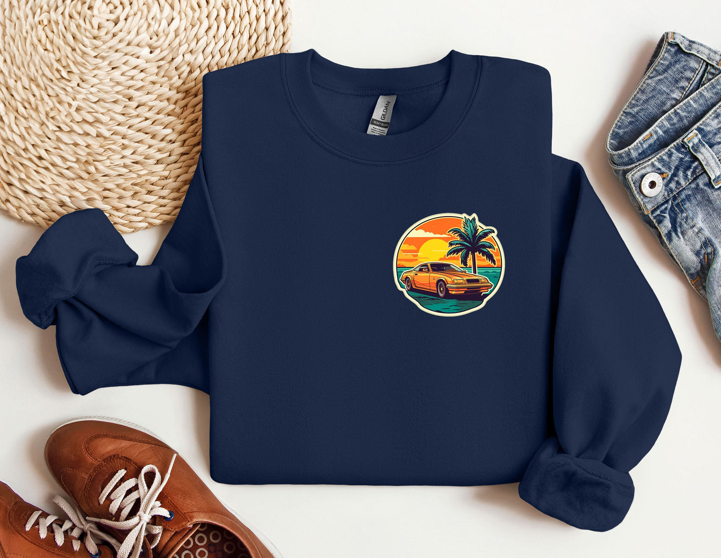 a blue sweatshirt with a picture of a car and palm trees on it