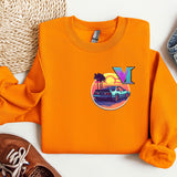 an orange sweatshirt with a vw logo on it next to a pair of shoes