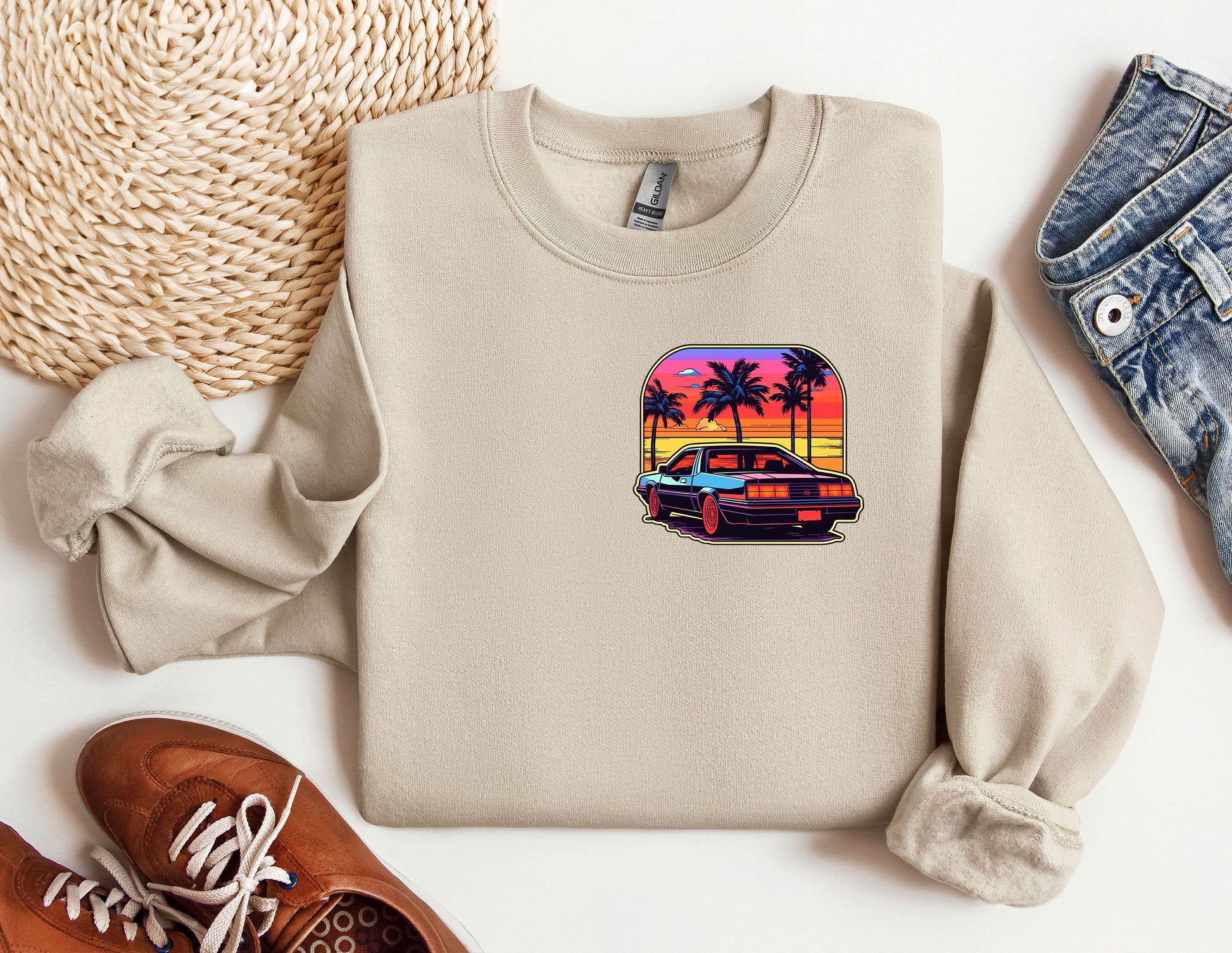 a sweater with a picture of a car and palm trees on it