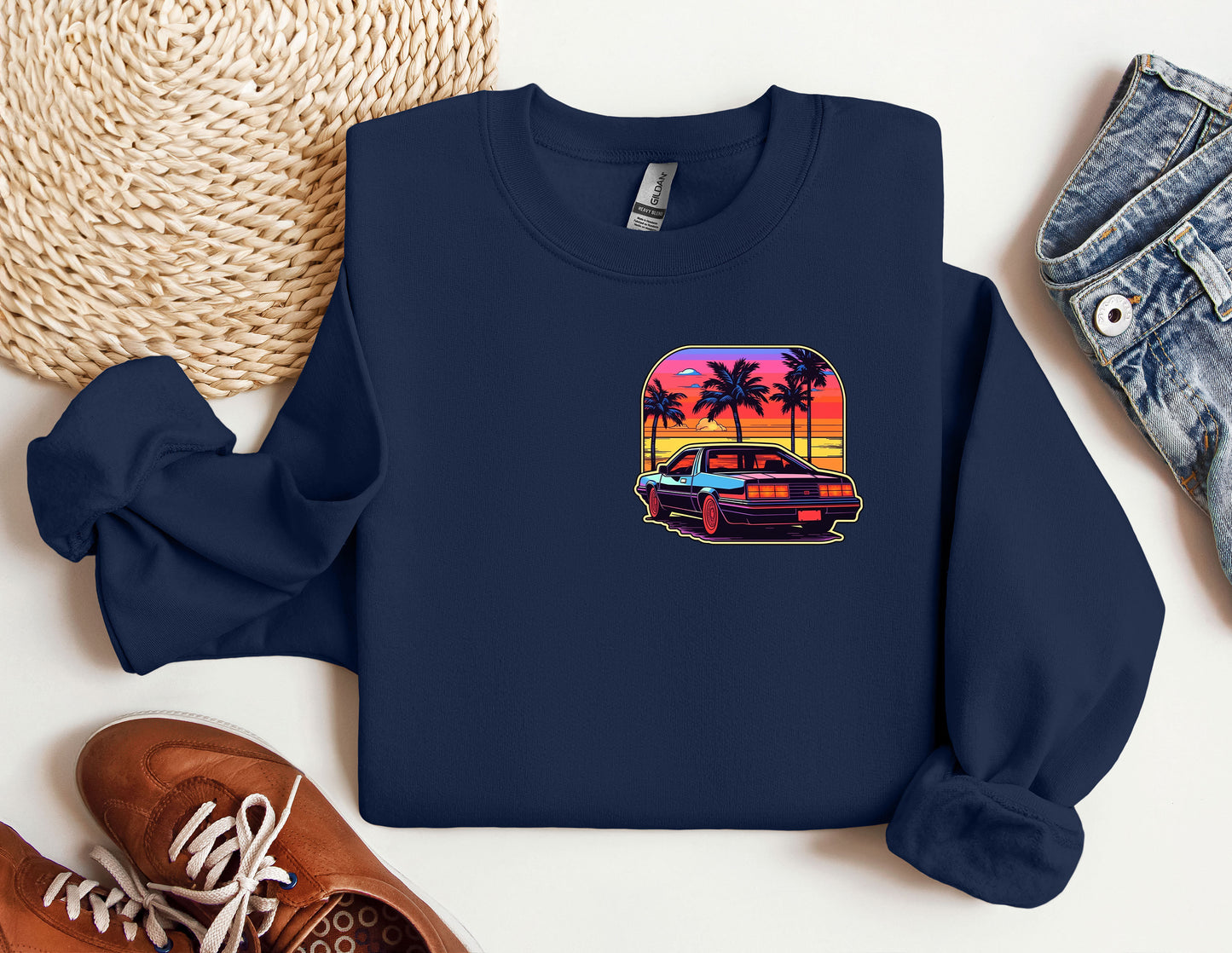 a blue shirt with a picture of a car and palm trees