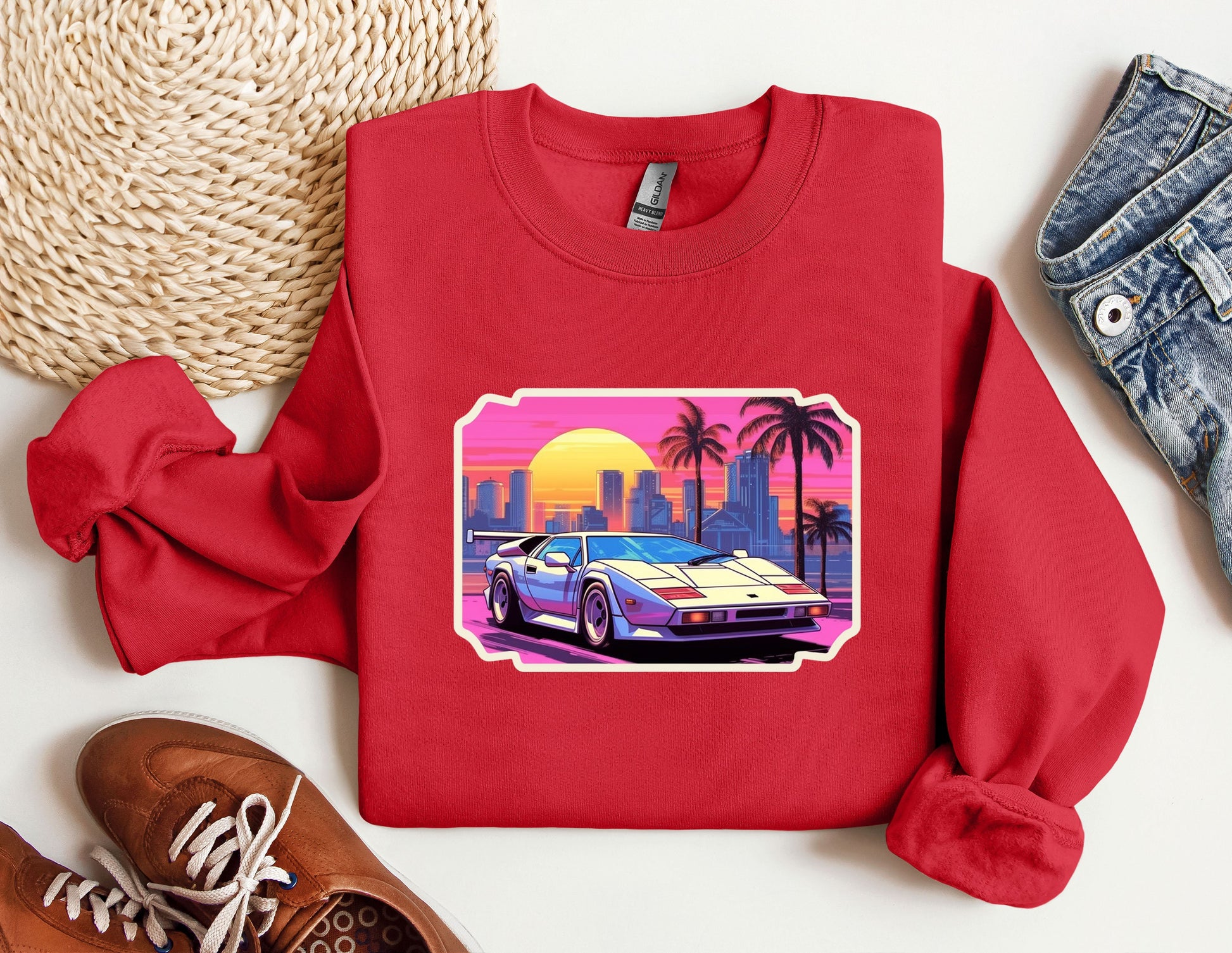 a red sweatshirt with a picture of a car on it