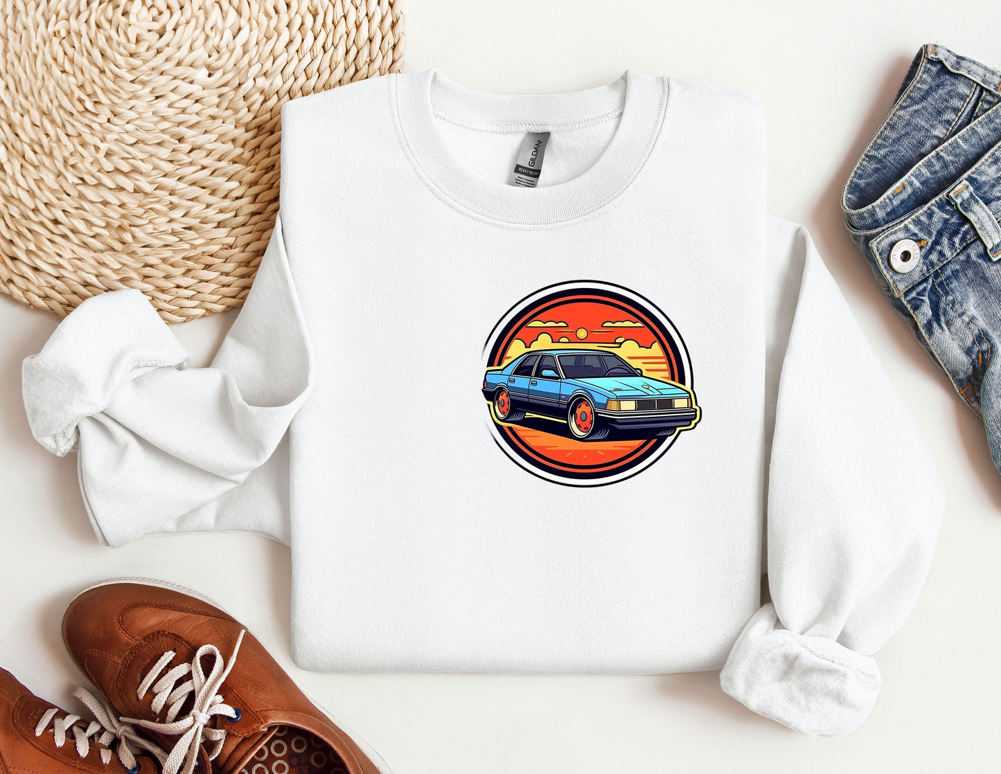 a white sweatshirt with a blue car on it