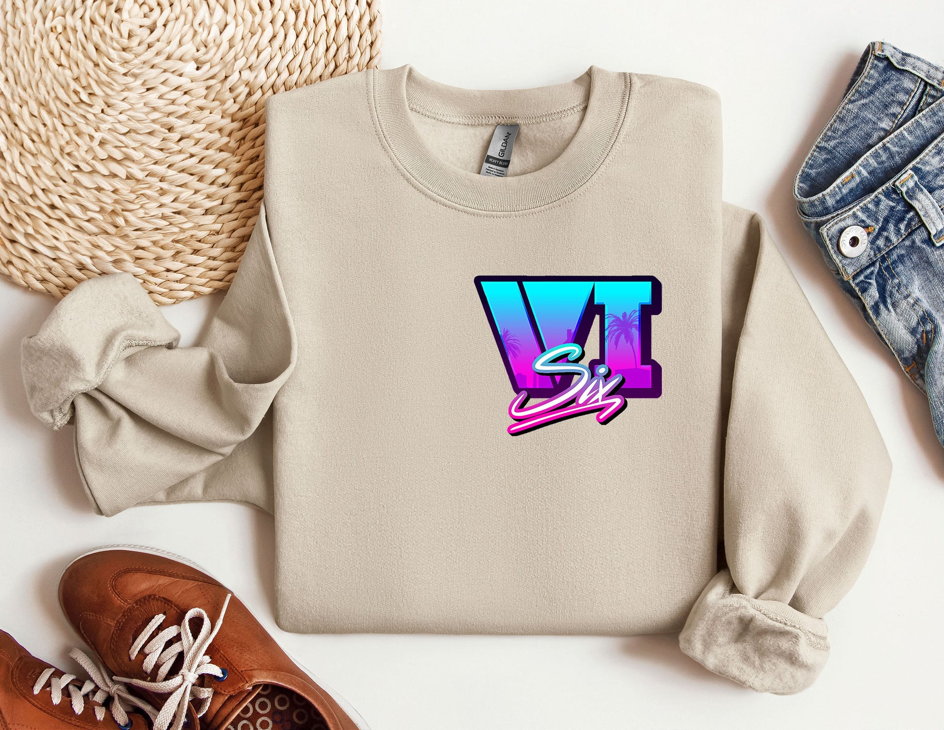 a sweater with the letter v on it next to a pair of shoes