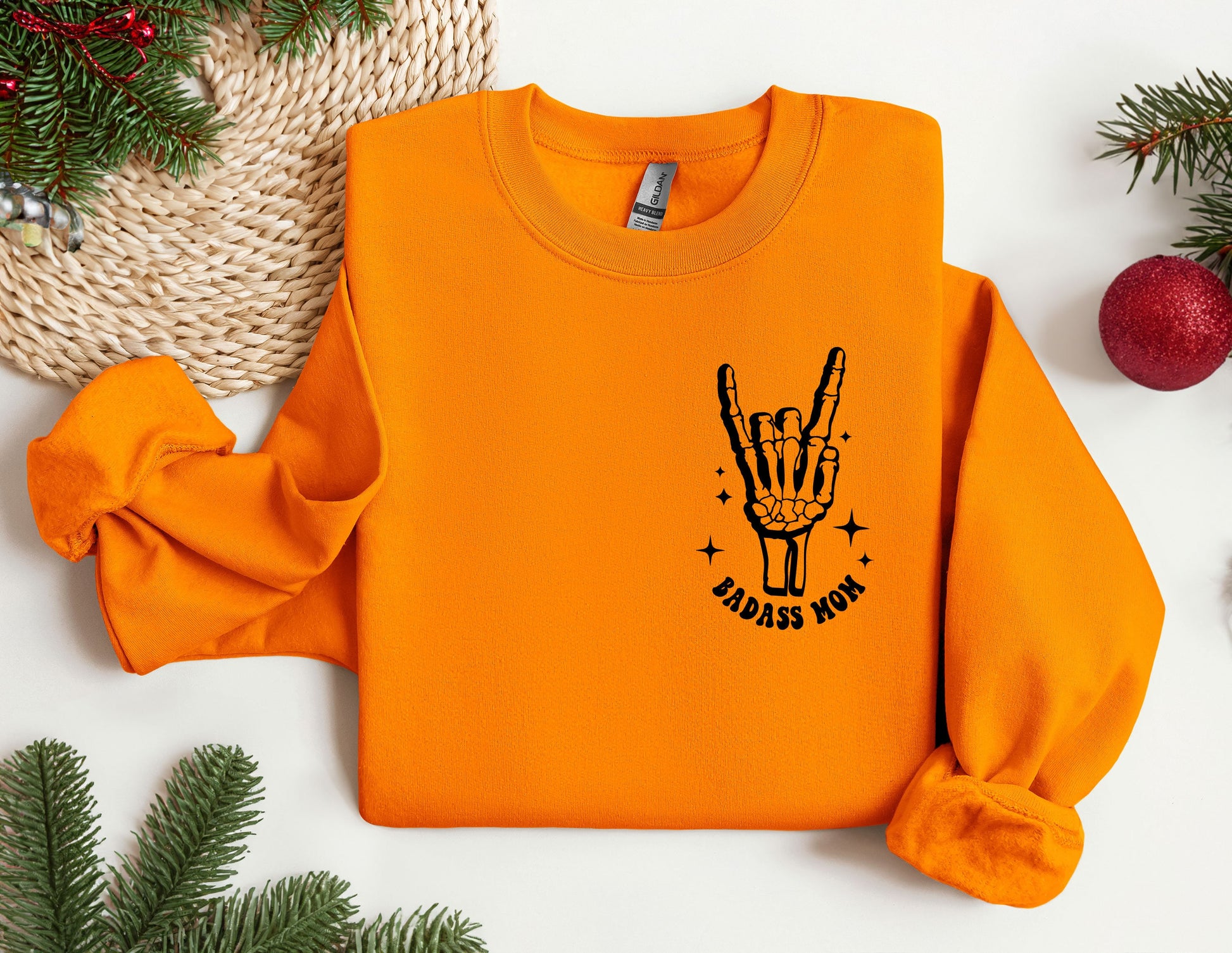 an orange sweatshirt with a hand drawn on it