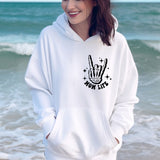 a woman wearing a white hoodie with a peace sign on it