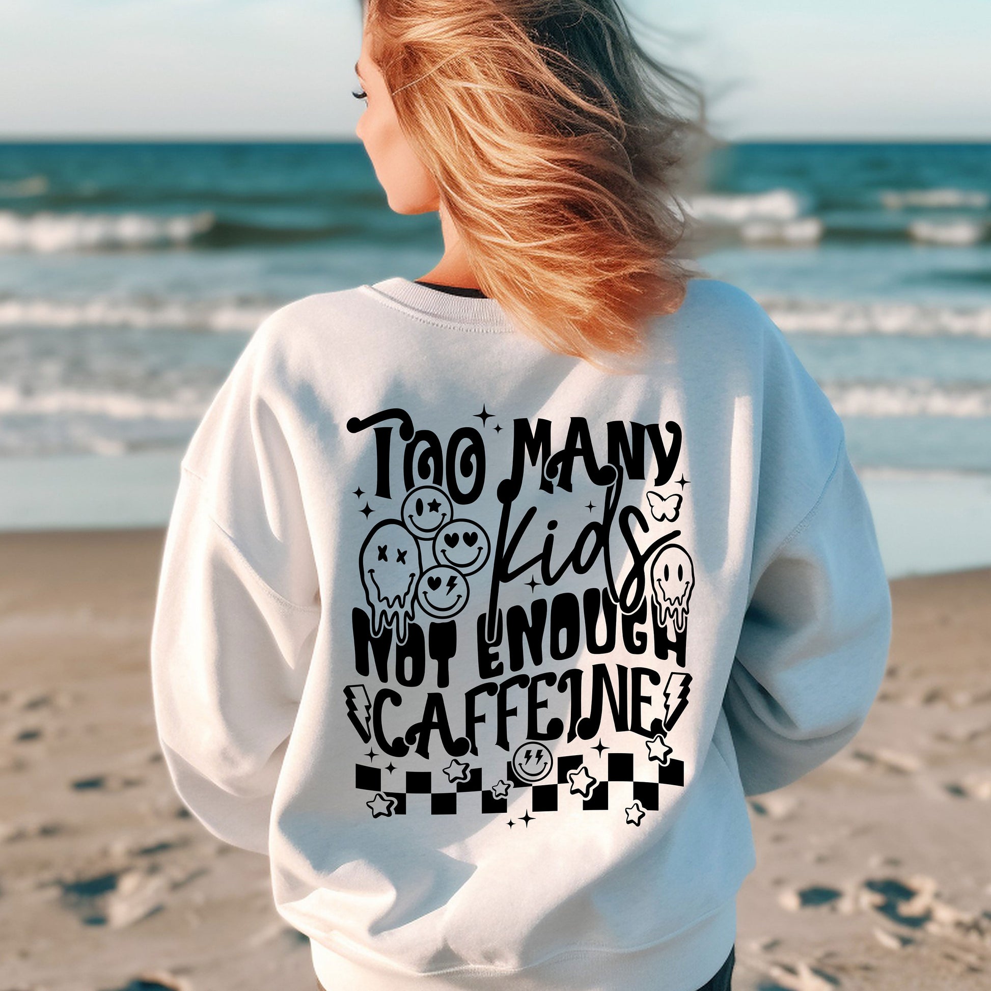 a woman standing on a beach with her back to the camera