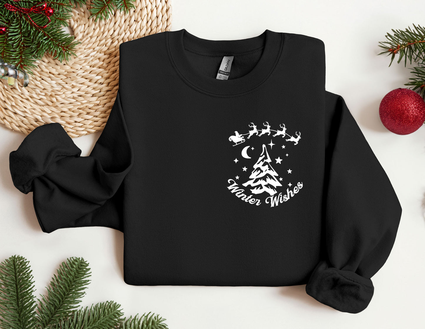 a black sweatshirt with a christmas tree and santa&#39;s sleigh on it