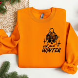 an orange sweater with a skull on it