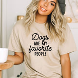 a woman wearing a t - shirt that says dogs are my favorite people
