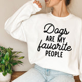 a woman wearing a sweatshirt that says dogs are my favorite people