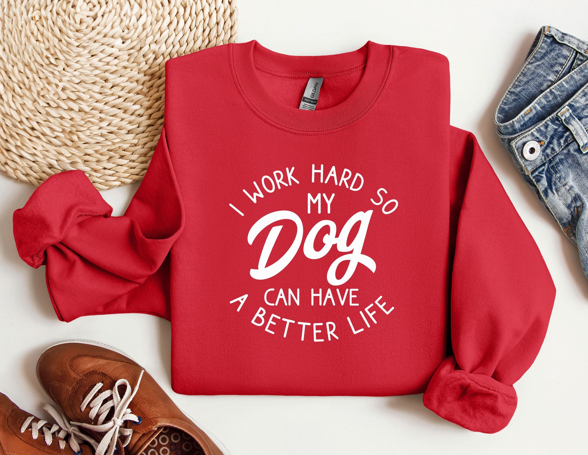 a red sweatshirt that says i work hard so my dog can have a better life