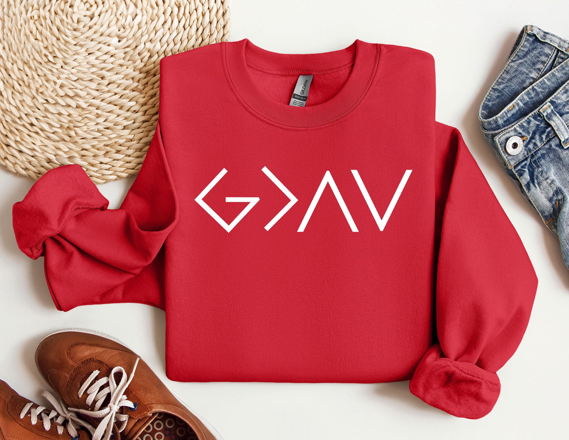 a red sweatshirt with the word gvg on it next to a pair of