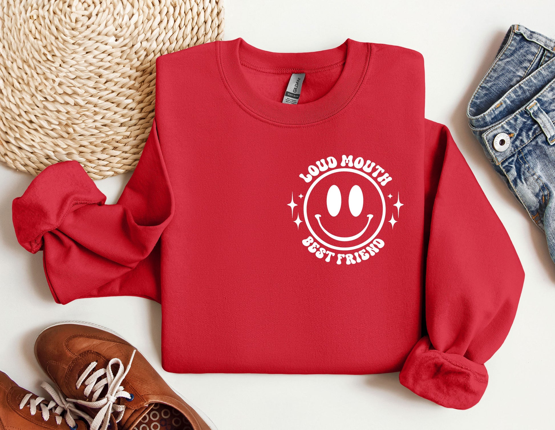 a red sweatshirt with a smiley face on it