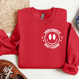 a red sweatshirt with a smiley face on it