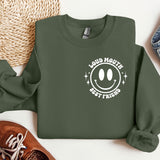a green sweatshirt with a smiley face on it