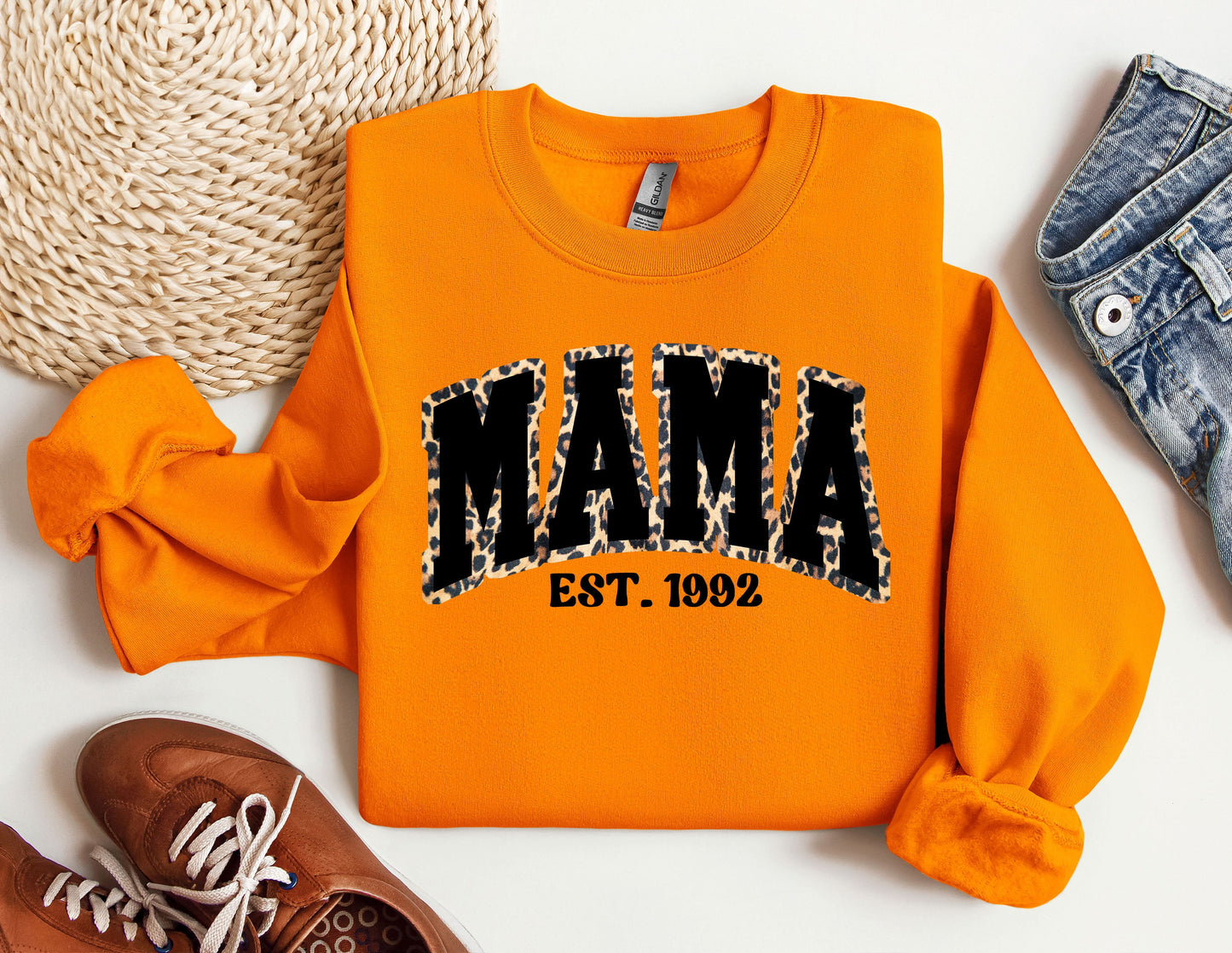 an orange sweatshirt with the word mama printed on it