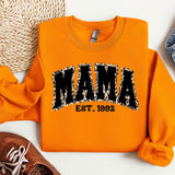 an orange sweatshirt with the word mama printed on it