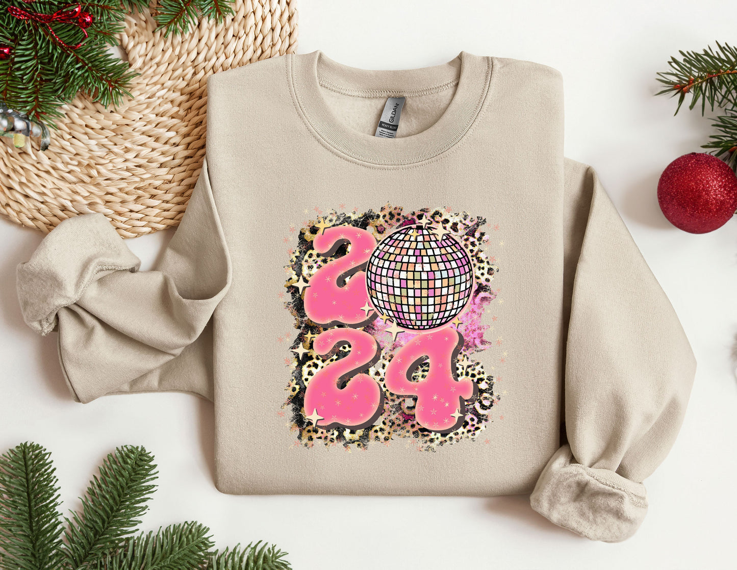 a sweater with a design on it next to a christmas tree