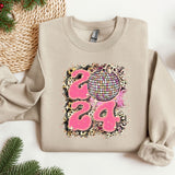 a sweater with a design on it next to a christmas tree