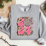 a sweater with a disco ball on it next to a christmas tree