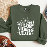 a green sweatshirt with white lettering on it next to a pair of shoes