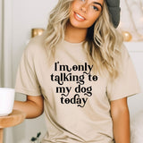 a woman wearing a t - shirt that says i'm only talking to my