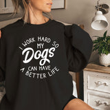 a woman sitting on a bed wearing a black sweatshirt