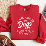 a red sweatshirt that says i work hard so my dogs can have a better life