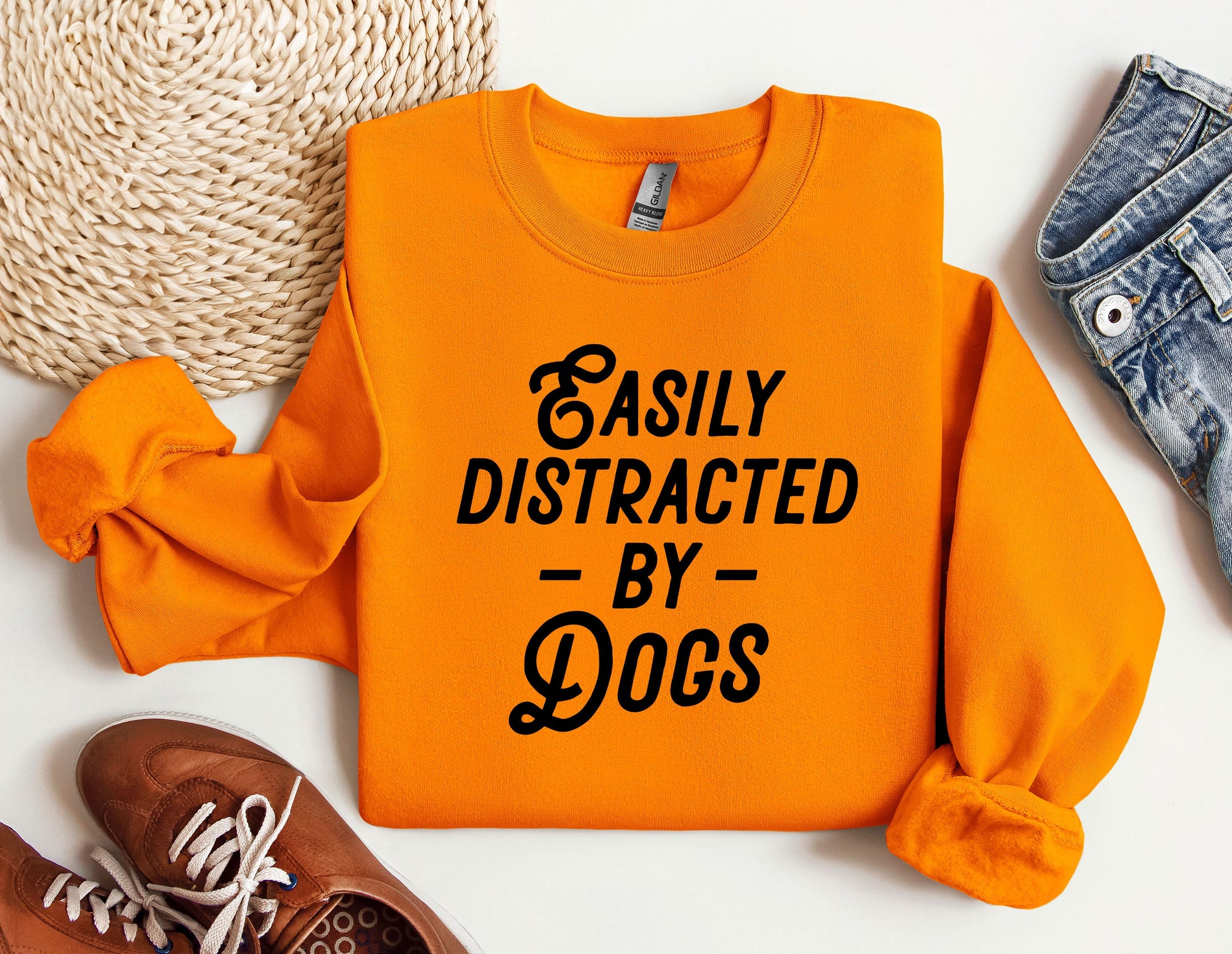 an orange sweatshirt that says easily distracted by dogs