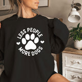 a woman sitting on a bed wearing a black shirt with a dog's paw