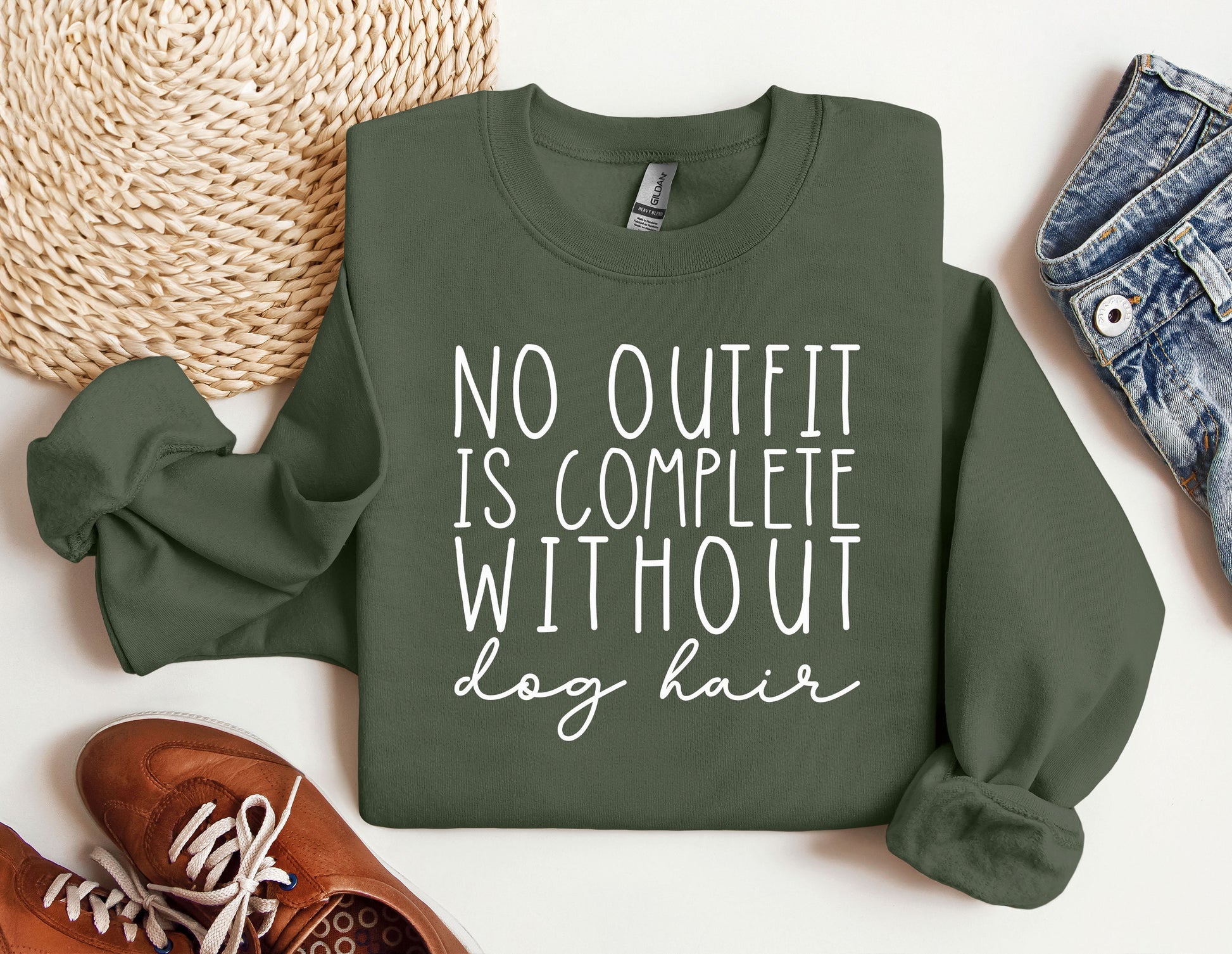 a sweatshirt that says no outfit is complete without dog hair