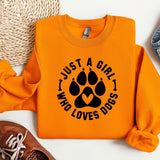 an orange shirt with a dog paw on it