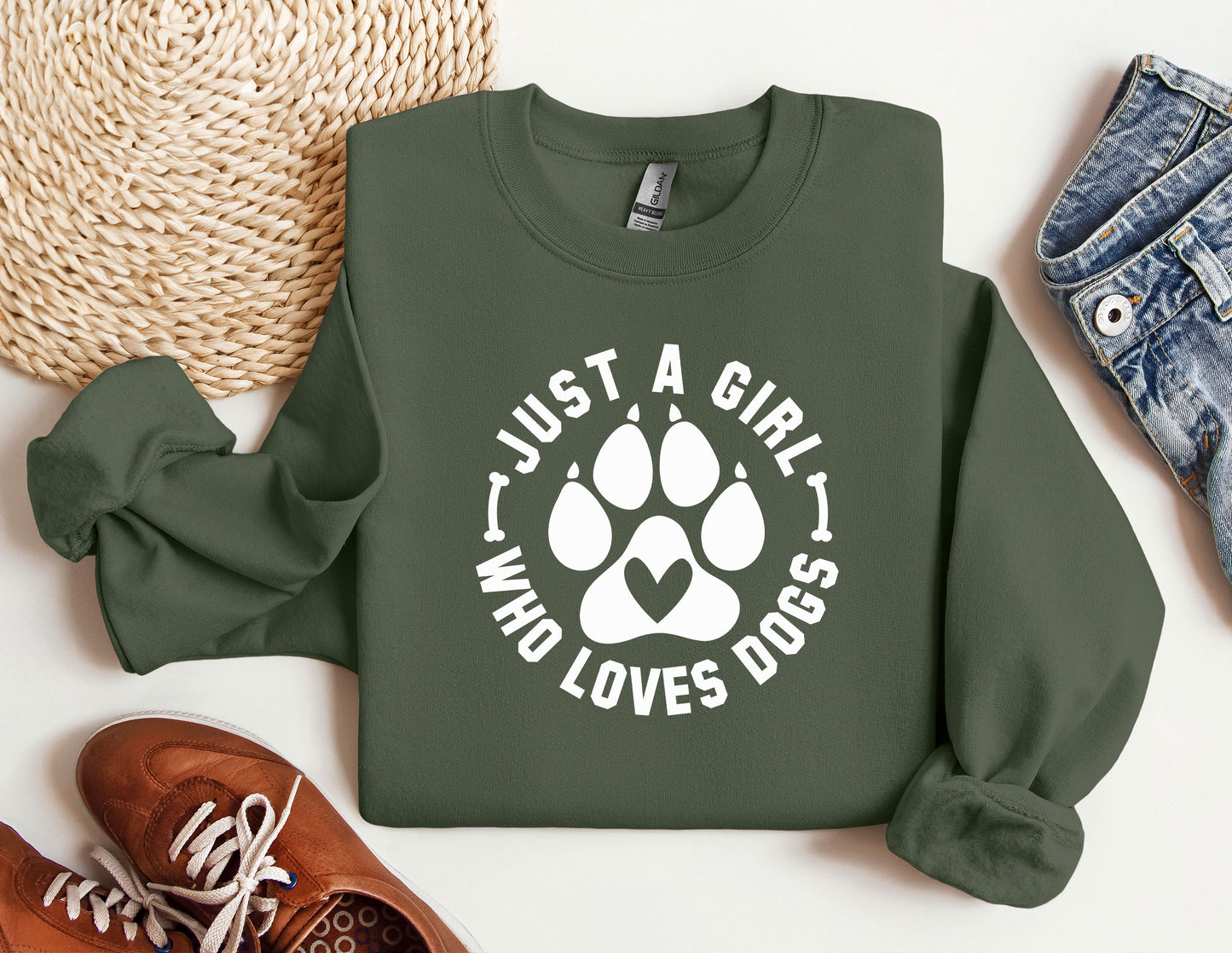a green sweatshirt with a white dog paw on it